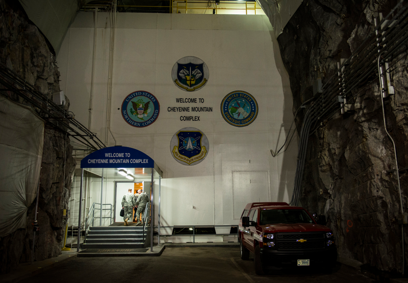 Lt. Gen Daniel R. Hokanson, the U.S. North Command deputy commander, and his staff walk into the Cheyenne Mountain Complex at Cheyenne Air Station, Colorado. Two thousand feet below the surface, buildings made of battleship steel sit on springs isolating them from earthquakes that could company a nuclear blast outside. (U.S. Air Force photo/Staff Sgt. Andrew Lee)